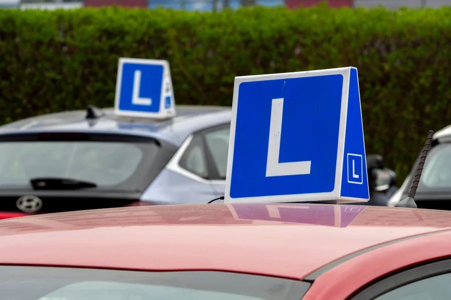 Learner driver L-sign on driving school cars